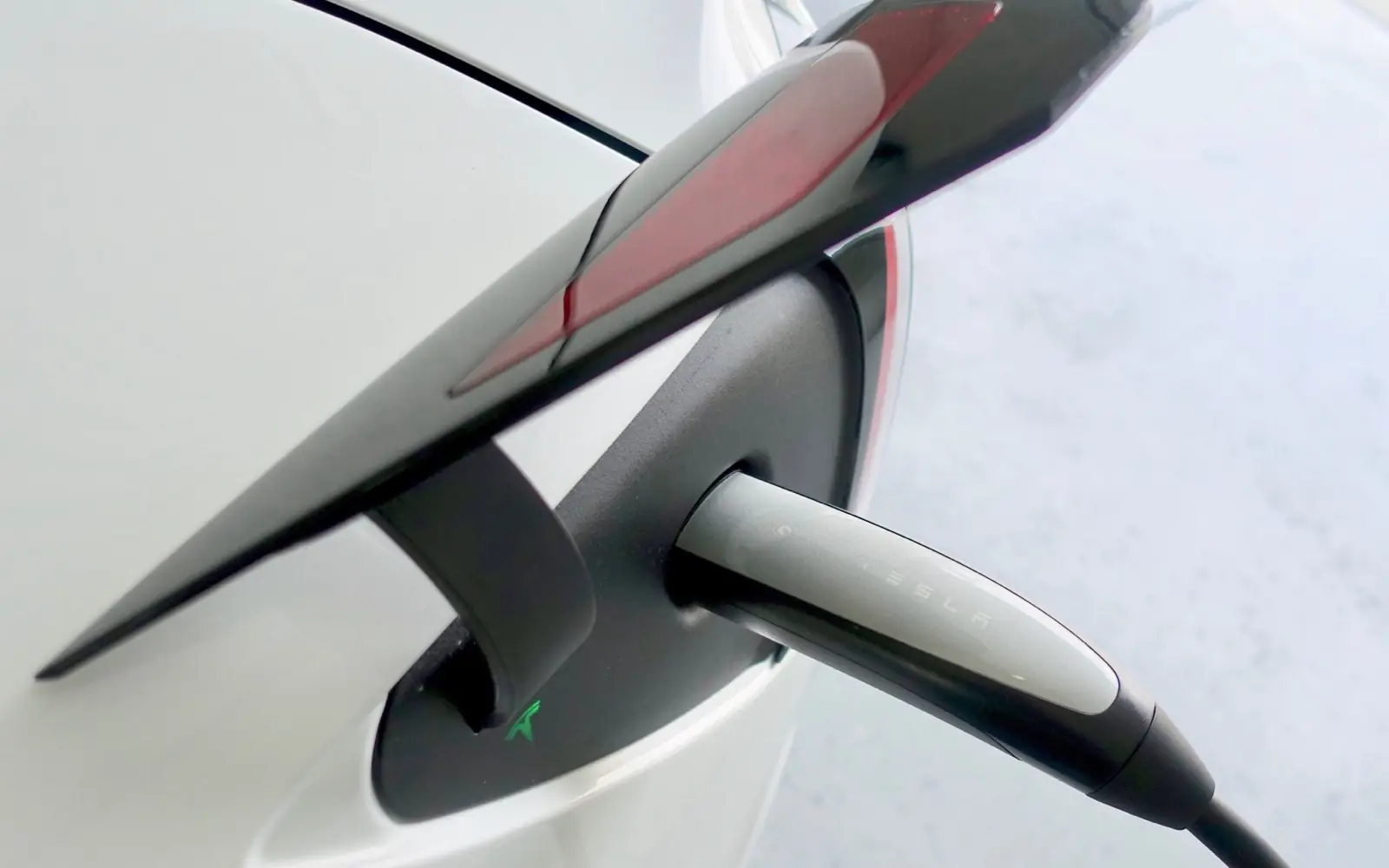 A Tesla charging with the NACS (North American Charging Standard) connector.
