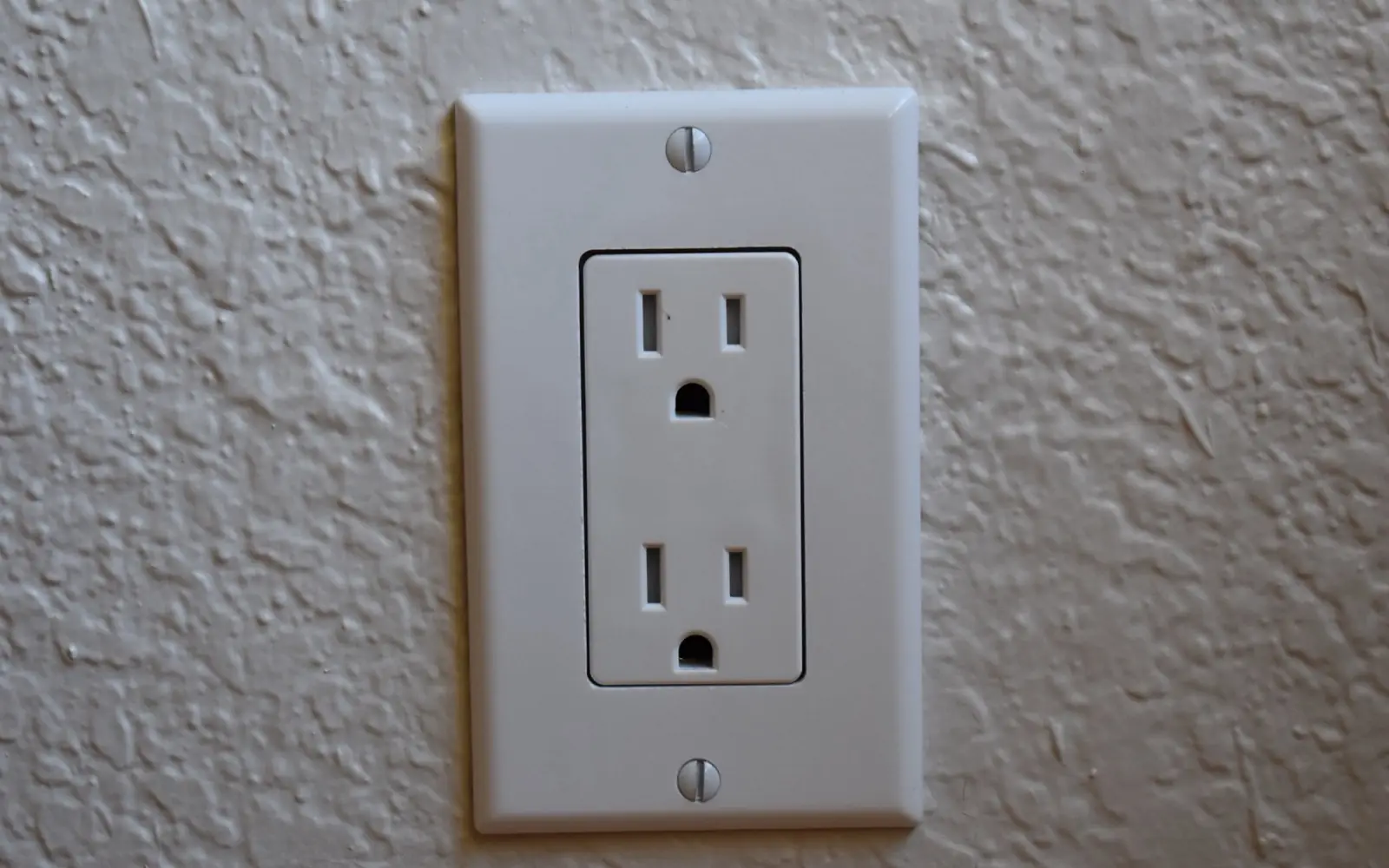 A standard NEMA 5-15 120-volt household wall outlet used for Level 1 EV charging.